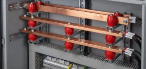 Busbar support insulators mounting copper busbars in an electrical enclosure