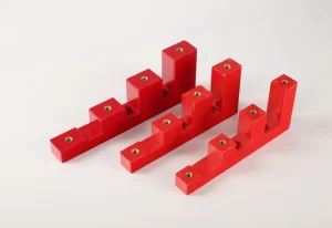 3 red CJ stepped busbar support insulators with four steps and brass threaded inserts